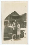 Two Women Standing in Front of Automobile