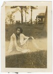 Woman Sitting in Yard