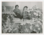 Eartha M.M. White and Daisy Ford Standing Behind Gifts
