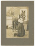 Eartha M.M. White Standing Next to A Horse