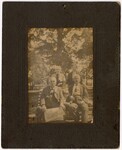 Four Unidentified Adults And A Child On A Bench