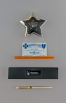 Rising Star paperweight, undated; Metal membership card and stand, Bob Fetzer, Blue Cross-Blue Shield 5 Year Club, undated; 50th Anniversary pen and box, 1994 by Blue Cross and Blue Shield of Florida, Inc.