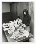 Employees Sort Through Large Stacks of Forms by Blue Cross of Florida, Inc. and Blue Shield of Florida, Inc.