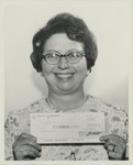 Catherine White Holding Suggestion Award Check by Blue Cross of Florida, Inc. and Blue Shield of Florida, Inc.