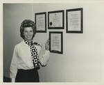 Margie Cook Standing Next to Four Awards by Blue Cross of Florida, Inc. and Blue Shield of Florida, Inc.