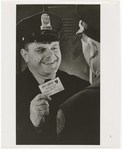 Promotional Photograph: Policeman With Blue Shield Insurance Card by Blue Cross and Blue Shield of Florida, Inc.