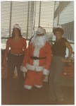 Two Employees With Santa Claus by Blue Cross and Blue Shield of Florida, Inc.