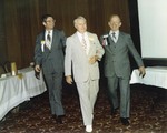 William E. Flaherty, J. W. Herbert, and Joe Matthews walking together
