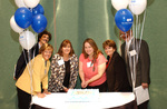 Cake cutting at 100th Grant Symposium with Susan Towler, Michael Hutton, and Susan Wildes by Blue Cross and Blue Shield of Florida, Inc.