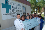Check presentation to Good News Care Center with Susan Towler by Blue Cross and Blue Shield of Florida, Inc.
