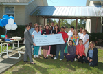 Check presentation to Acorn Clinic with Susan Towler by Blue Cross and Blue Shield of Florida, Inc.