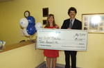 Check presentation to United Ministries with Michael Sutton by Blue Cross and Blue Shield of Florida, Inc.