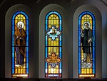 Triple Windows Showing Moses, a ship, the Ark of the Covenant, and St. Martin de Porres by James Dwight Davis
