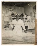 Photograph: Portrait, Unidentified Woman Standing Behind Counter by R. Lee Thomas