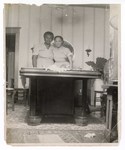 Photograph: Portrait, Two Women Standing Behind Table by R. Lee Thomas