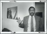 Dr. Buck Standing in Dorm Room by Spinnaker Media